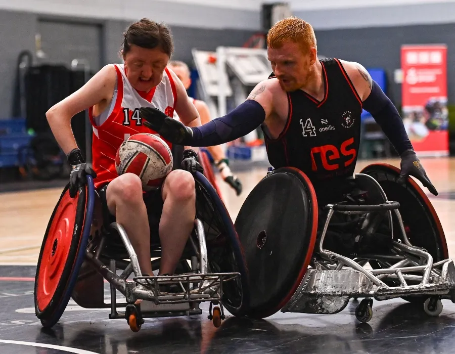female and male wheelchair rugby players in action